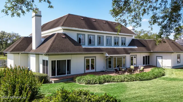 a living room with fireplace furniture and a rug