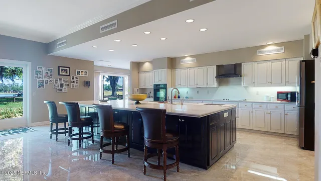 a kitchen with a stove sink and cabinets