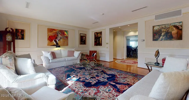 a living room with furniture a rug and a window