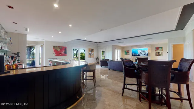 a living room with furniture and a dining table with kitchen view