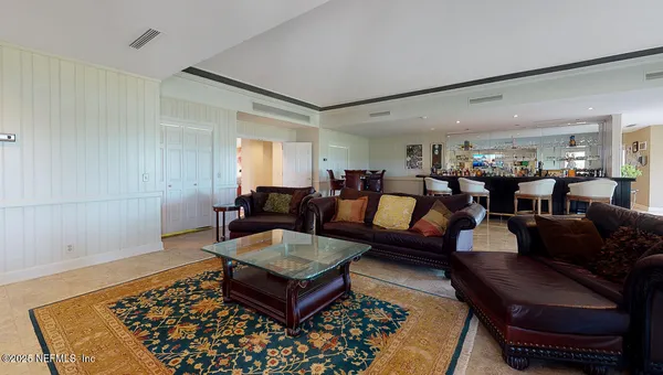a hallway with white cabinets and wooden floor