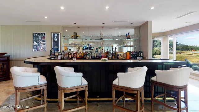 a dining area with stainless steel appliances kitchen island a table and chairs