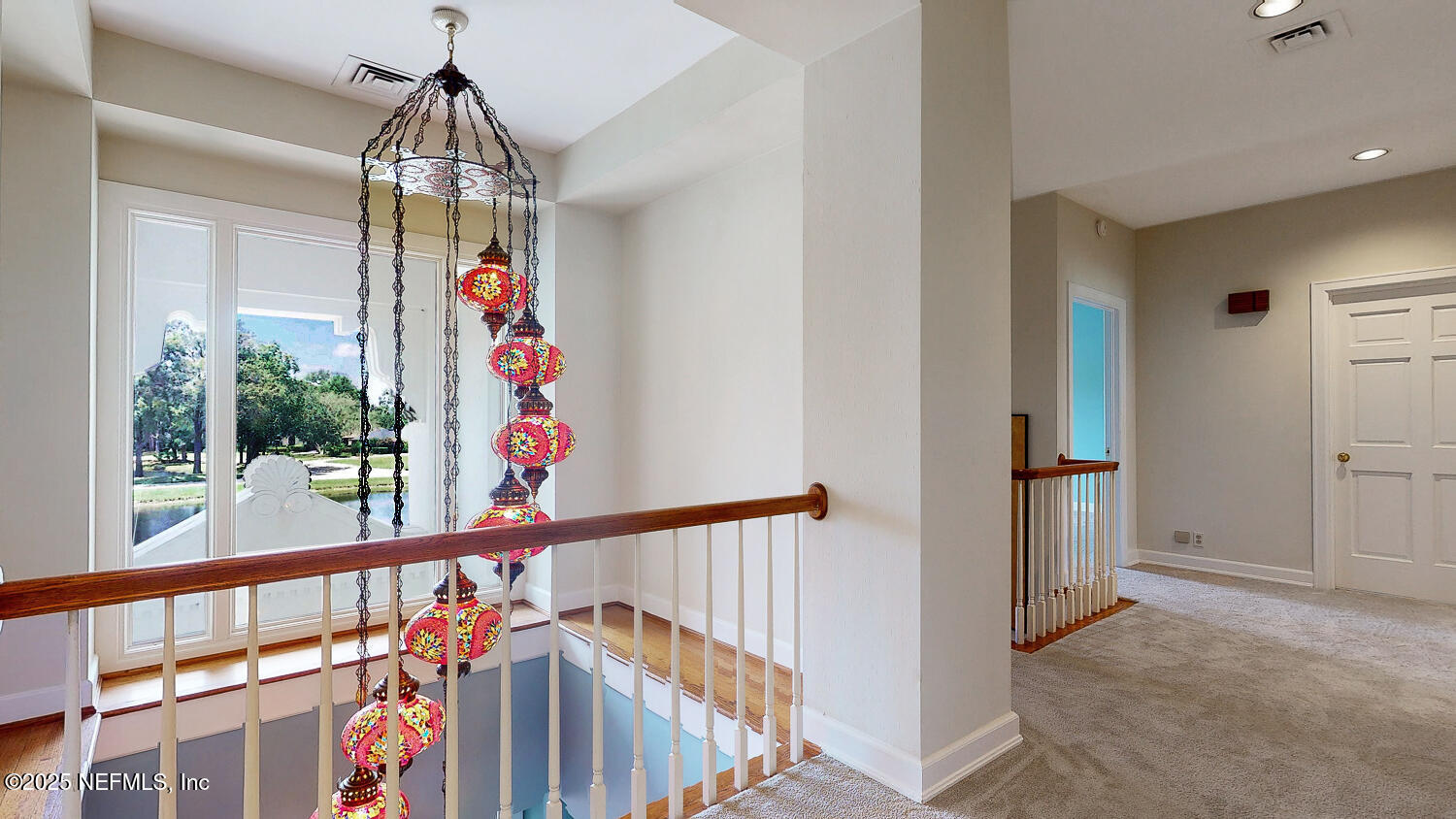 7987 Hollyridge Road Jacksonville, FL 32256 - Photo 51 of 55 a view of a hallway with a chandelier
