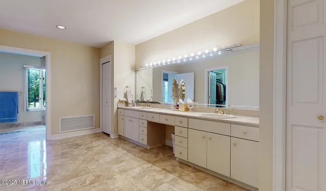 a spacious bathroom with a granite countertop sink mirror and a