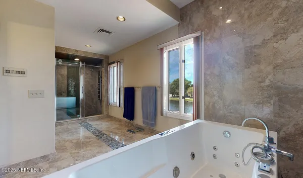 a bathroom with a bathtub and a sink