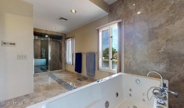 a bathroom with a bathtub and a sink