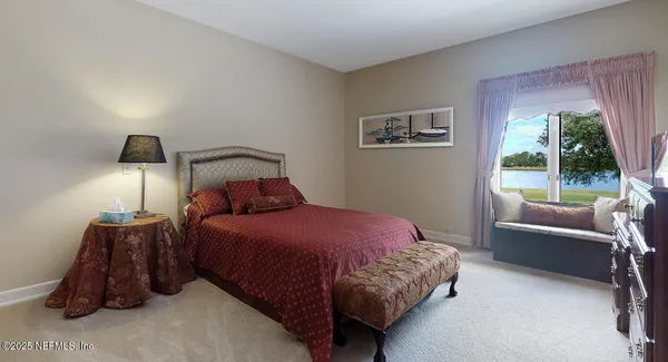 a bed sitting in a bedroom next to a window