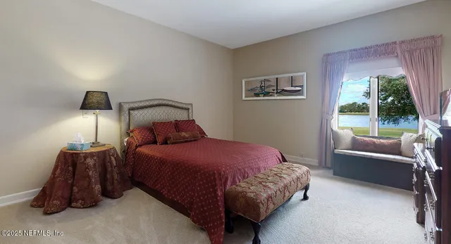 a bed sitting in a bedroom next to a window