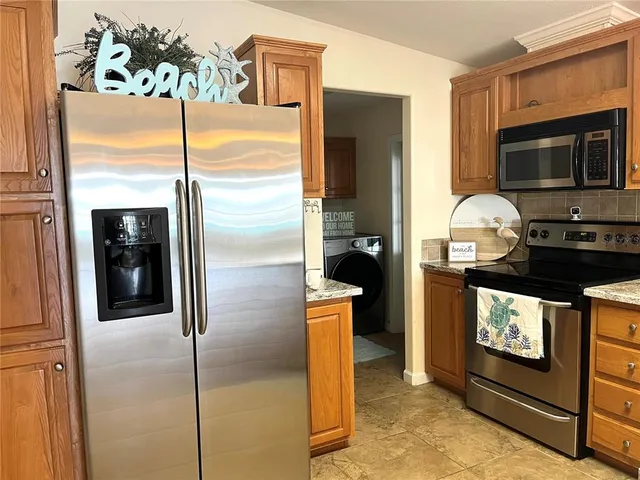 a kitchen with stainless steel appliances a stove a microwave and cabinets