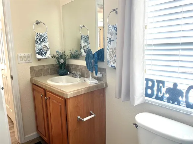 a large bed sitting in a bedroom next to a window