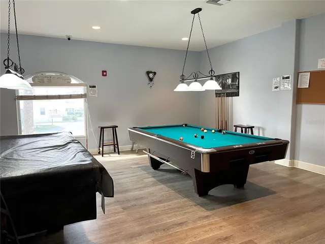 a view of a chairs and table on the roof deck