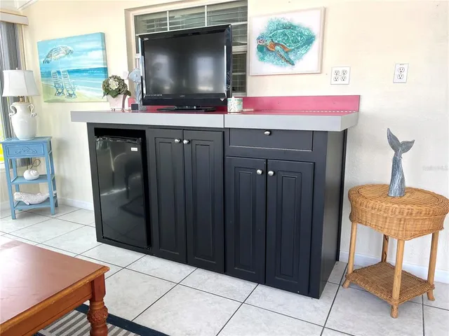 a living room with furniture and floor to ceiling windows