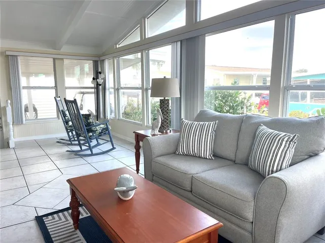a dining room with furniture and large windows