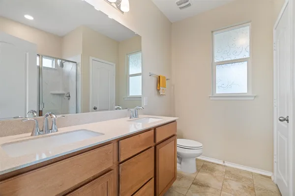 a view of an empty room with window and closet area