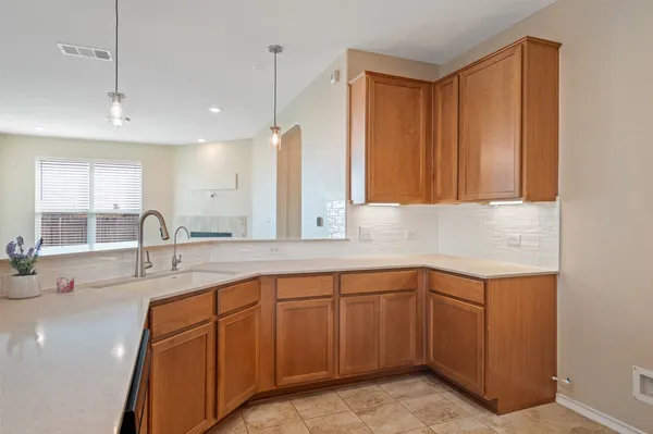 a kitchen with a sink and cabinets