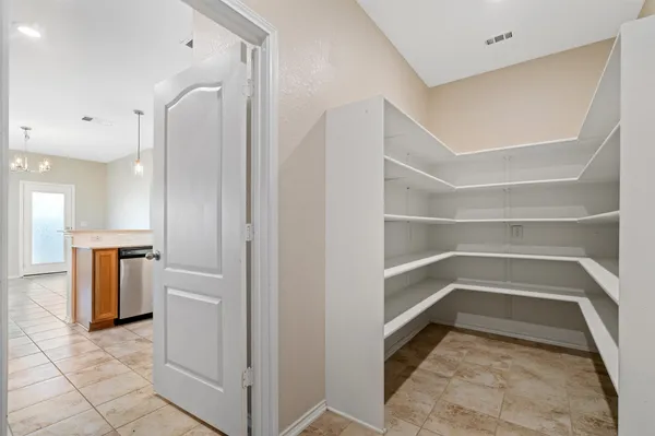 a view of a hallway with wooden shelves