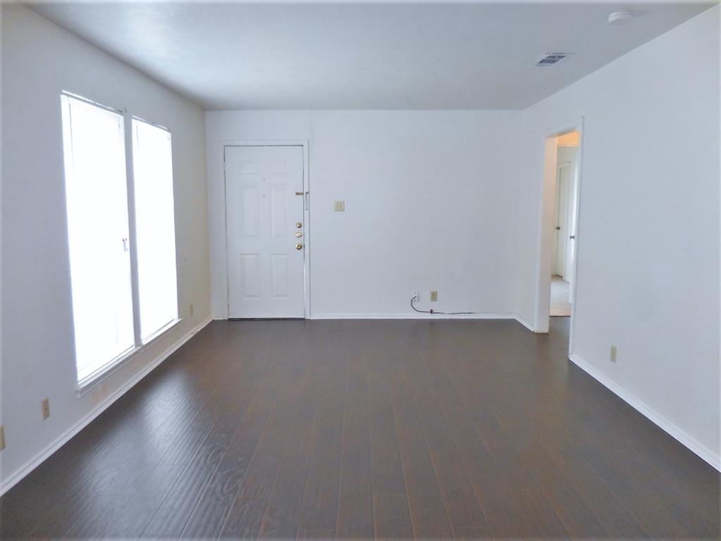 3307 Gardenview Circle Denton, TX 76207 - Photo 2 of 11 an empty room with wooden floor and windows
