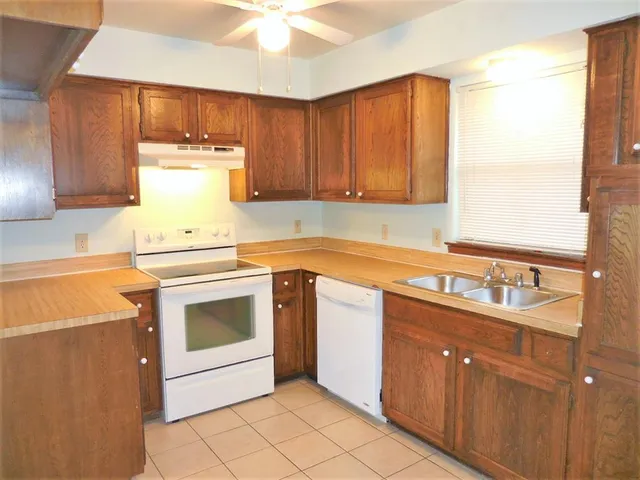 a kitchen with a sink stove and cabinets