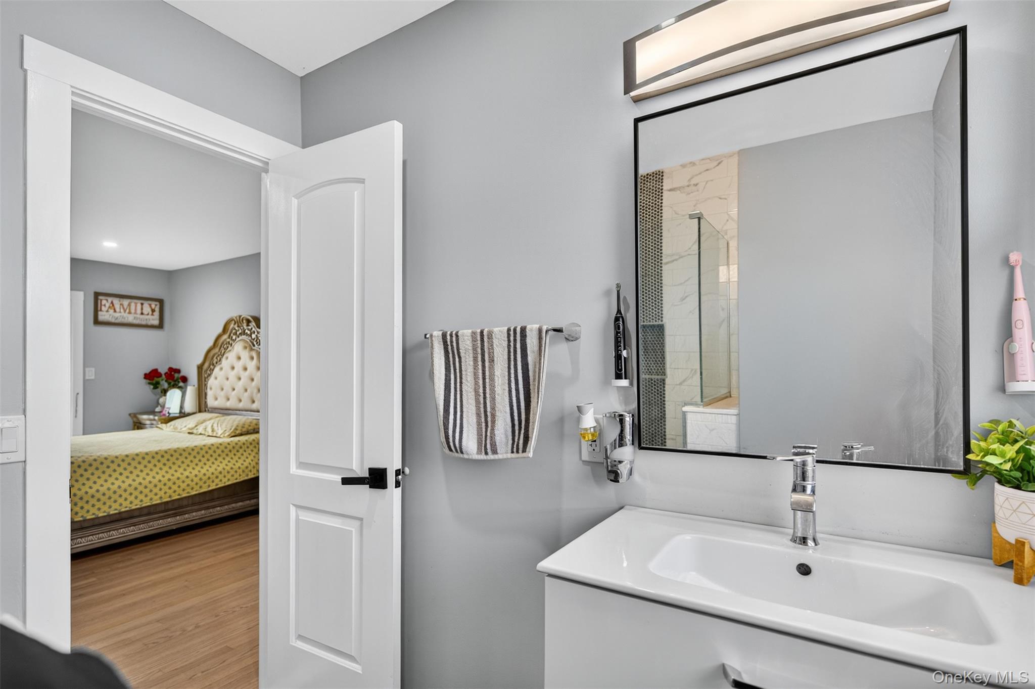 88 Spackenkill Road Poughkeepsie, NY 12603 - Photo 18 of 22 a en suite bathroom with a sink and a mirror