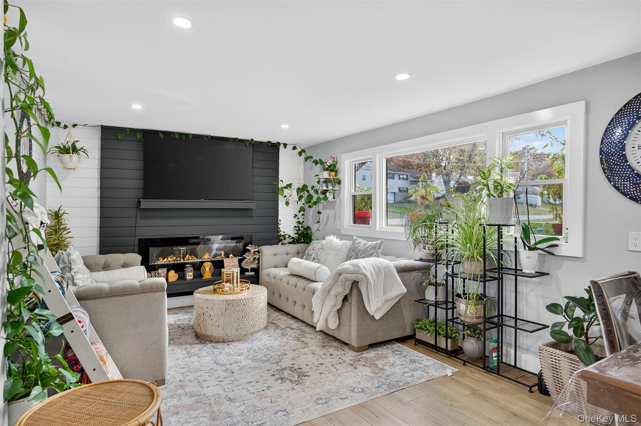88 Spackenkill Road Poughkeepsie, NY 12603 - Photo 4 of 22 a living room with furniture a flat screen tv and a floor to ceiling window
