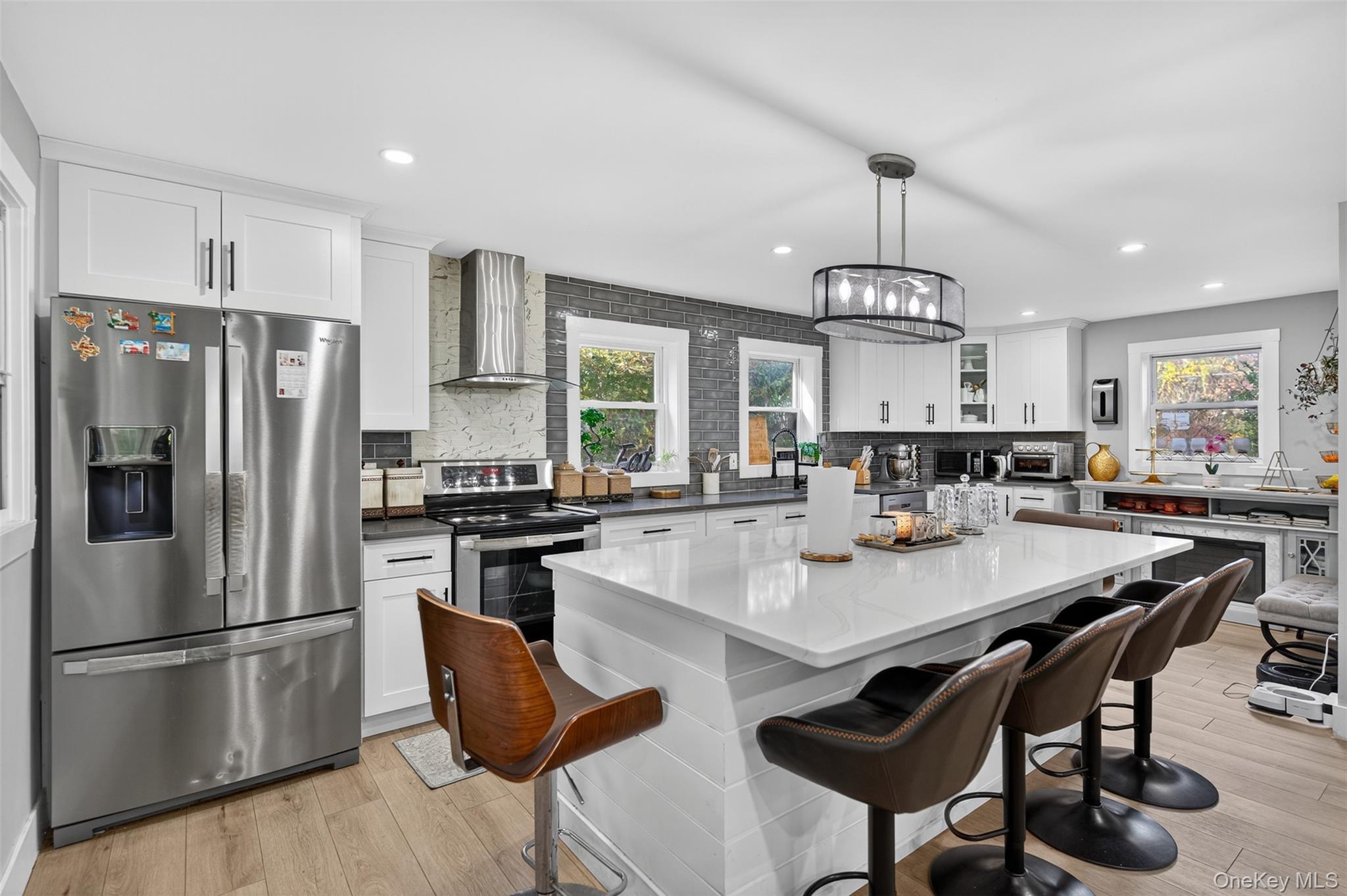 88 Spackenkill Road Poughkeepsie, NY 12603 - Photo 7 of 22 a kitchen with refrigerator a stove a dining table and chairs
