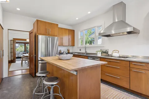 a kitchen with stainless steel appliances granite countertop a sink a stove and a refrigerator