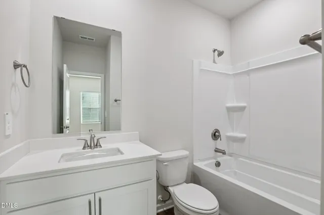 a view of an empty room with wooden floor and closet
