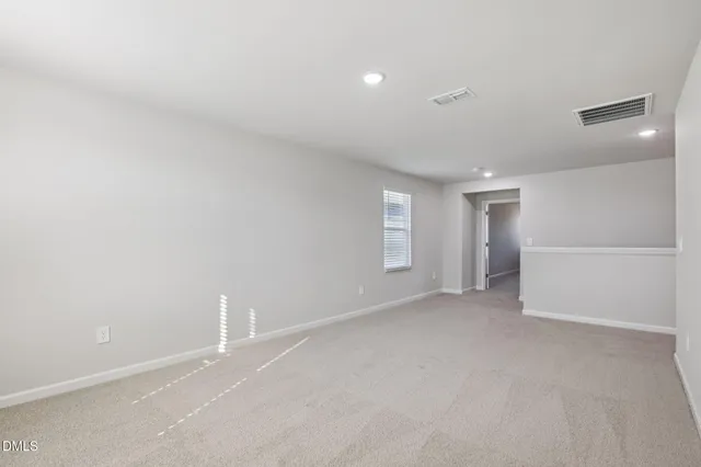 an empty room with a empty space and windows