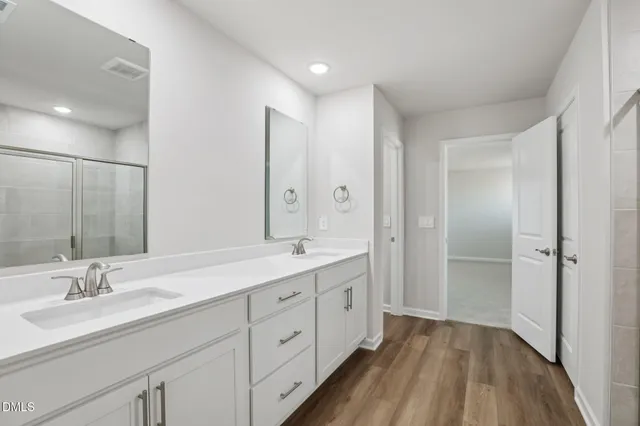 a spacious bathroom with a double vanity sink and a mirror