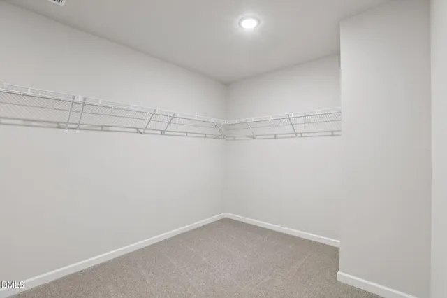 a spacious bathroom with a double vanity sink a mirror and a shower