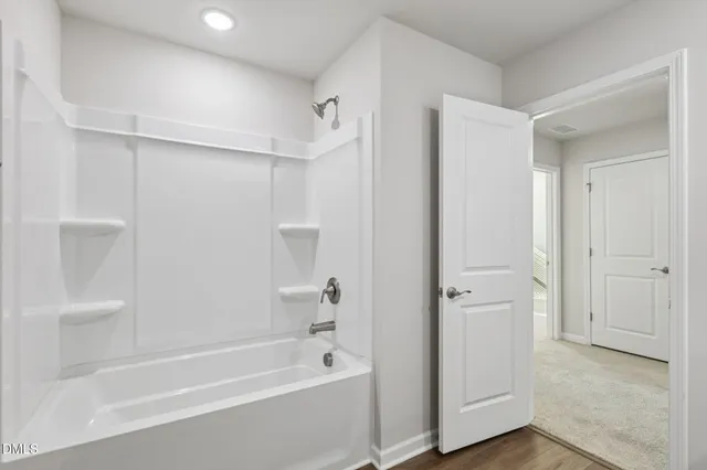 a bathroom with a granite countertop sink a toilet and a mirror
