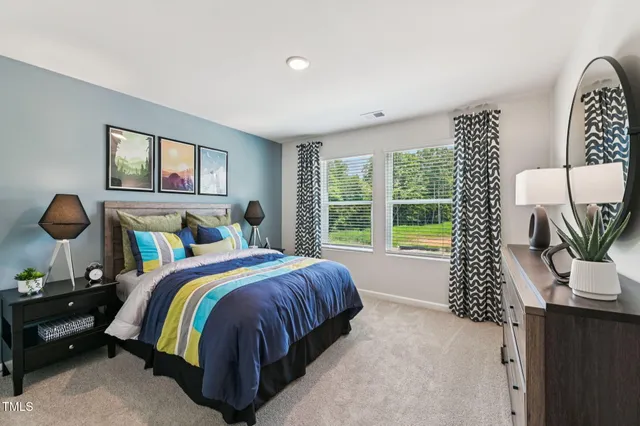 a bedroom with a bed and a dresser