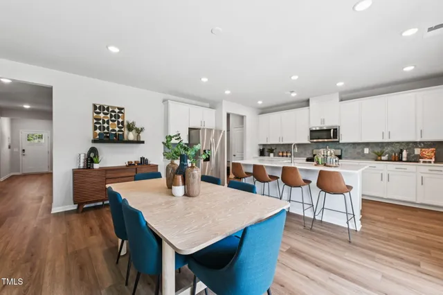 a view of a dining room with furniture and wooden floor