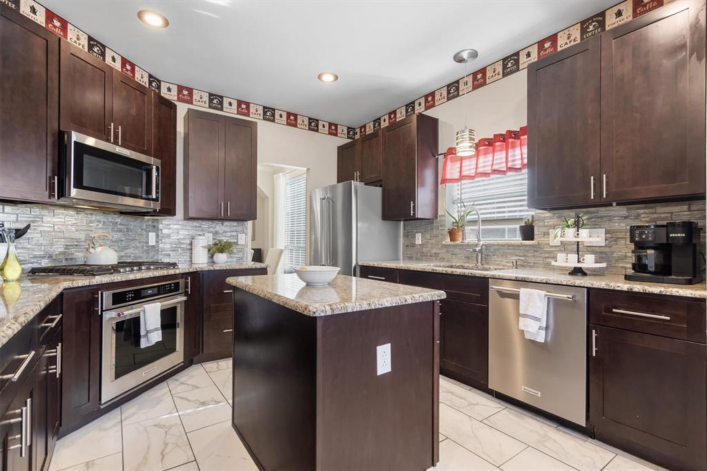 1017 Tanglewood Lane Flower Mound, TX 75028 - Photo 12 of 38 The kitchen offers generous prep space and storage, making cooking feel effortless and enjoyable.