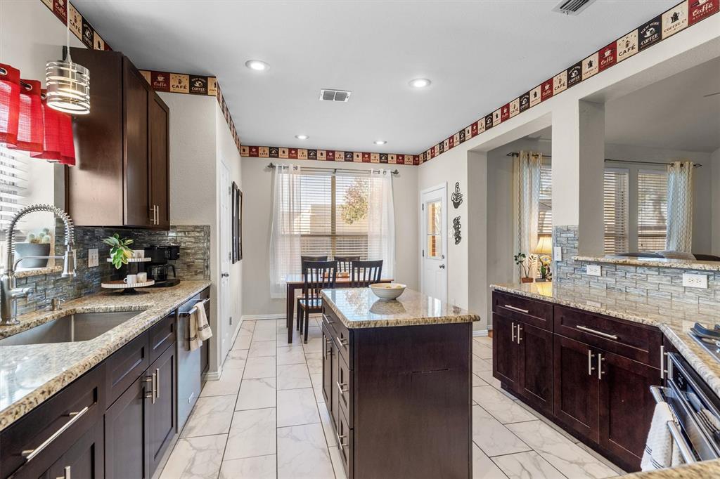 1017 Tanglewood Lane Flower Mound, TX 75028 - Photo 16 of 38 Bright and airy, this kitchen is a space you’ll enjoy spending time in every day.