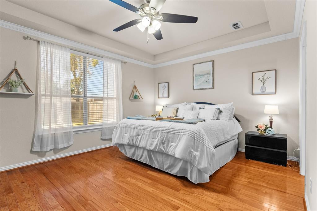 1017 Tanglewood Lane Flower Mound, TX 75028 - Photo 19 of 38 A peaceful bedroom retreat gives you room to unwind, work, or dream.