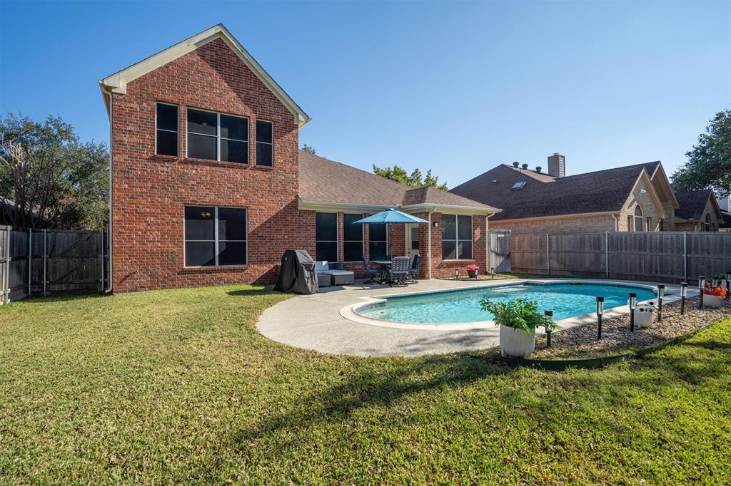 1017 Tanglewood Lane Flower Mound, TX 75028 - Photo 30 of 38 The sparkling pool transforms the backyard into your own private resort, perfect for warm Texas days.