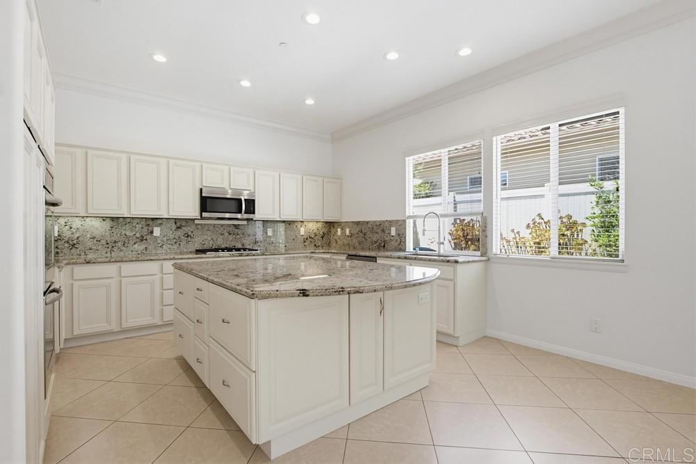 672 Inverlochy Drive Fallbrook, CA 92028 - Photo 20 of 75 a kitchen with a sink stove and cabinets