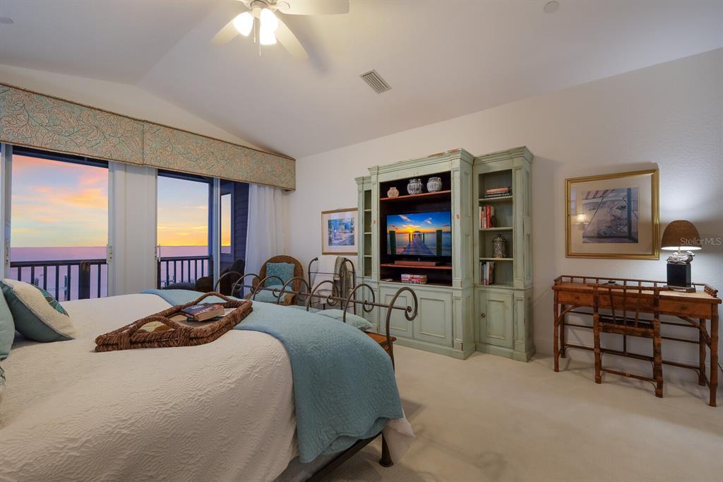 549 Buttonwood Bay Drive Boca Grande, FL 33921 - Photo 13 of 57 a bedroom with a bed and a flat screen tv