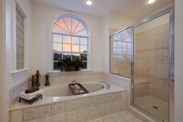 a spacious bathroom with a sink a vanity a mirror and shower