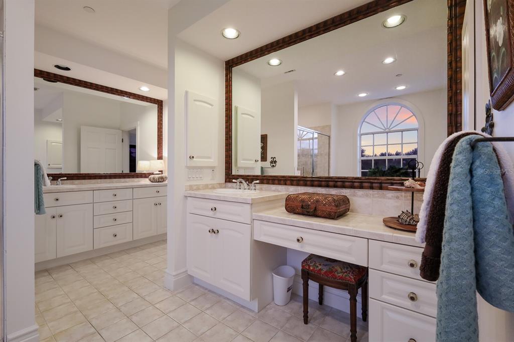 549 Buttonwood Bay Drive Boca Grande, FL 33921 - Photo 15 of 57 a spacious bathroom with a sink a vanity a mirror and shower