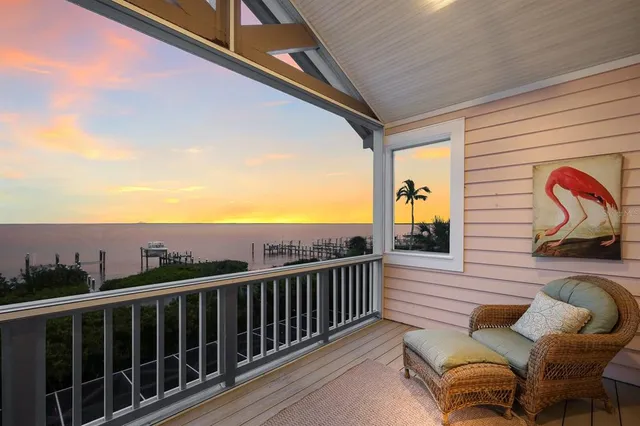 a bedroom with a bed a chandelier and a window