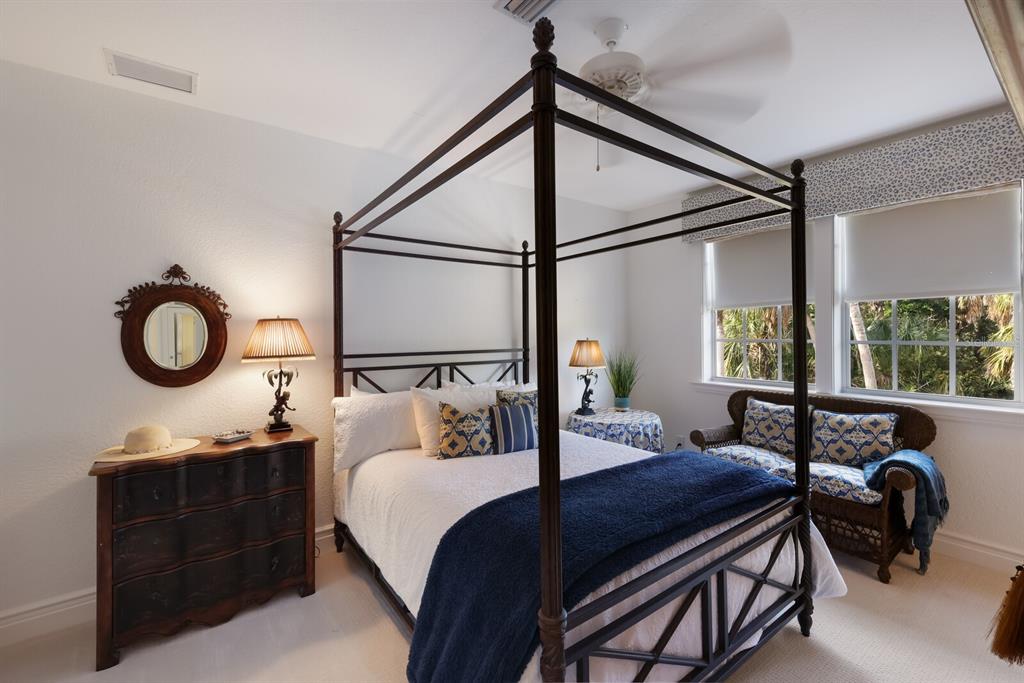 549 Buttonwood Bay Drive Boca Grande, FL 33921 - Photo 18 of 57 a bedroom with a bed a chandelier and a window