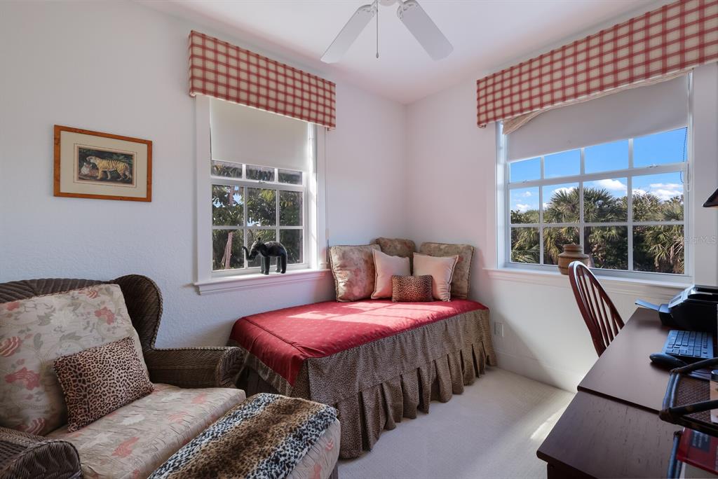 549 Buttonwood Bay Drive Boca Grande, FL 33921 - Photo 23 of 57 a bedroom with furniture and a large window