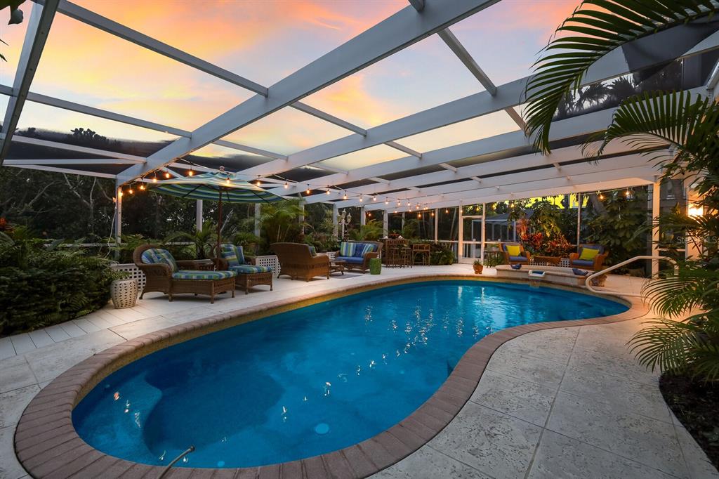 549 Buttonwood Bay Drive Boca Grande, FL 33921 - Photo 25 of 57 a view of a swimming pool with sitting area