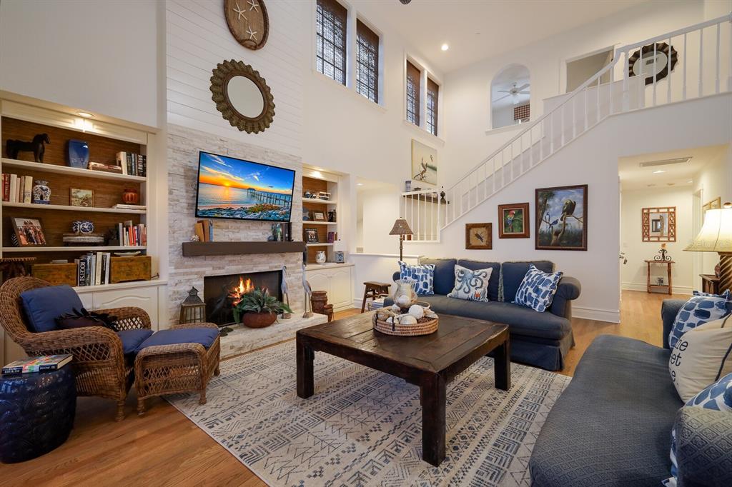 549 Buttonwood Bay Drive Boca Grande, FL 33921 - Photo 4 of 57 a living room with furniture a fireplace and a flat screen tv
