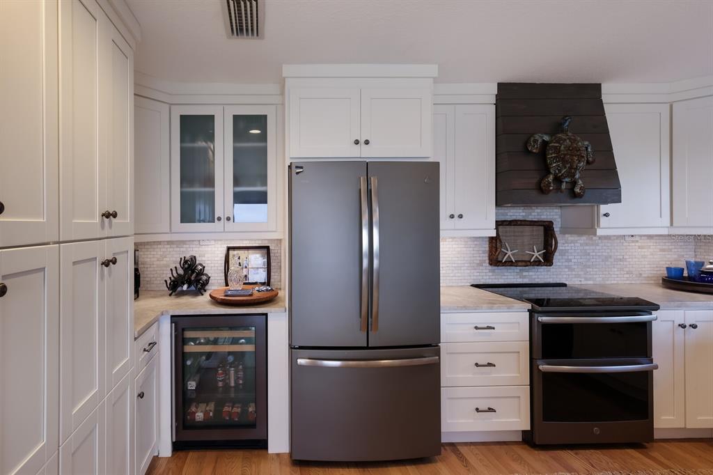 549 Buttonwood Bay Drive Boca Grande, FL 33921 - Photo 6 of 57 a kitchen with stainless steel appliances granite countertop a refrigerator and a stove top oven