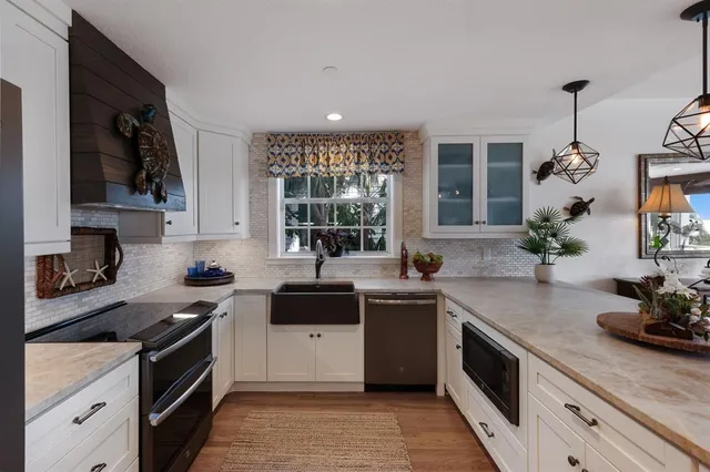 a kitchen with a sink stove and cabinets