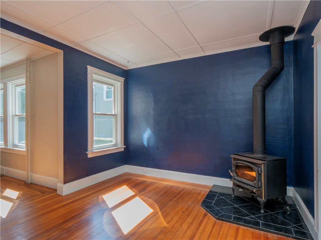 573 Spring Street Newport, RI 02840 - Photo 22 of 50 Back Sitting room off dining area with wood stove & view to dining area