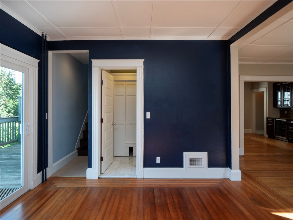 573 Spring Street Newport, RI 02840 - Photo 23 of 50 Back Sitting room off dining area with wood stove view to bathroom, sliders to back deck , back stairway & kitchen